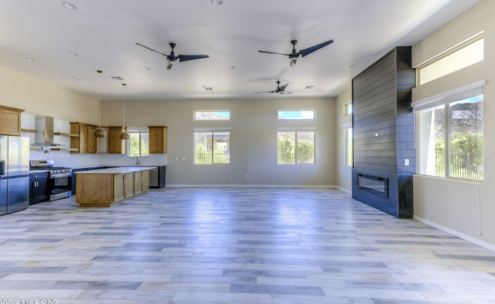 a large open kitchen with a ceiling fan and a ceiling fan