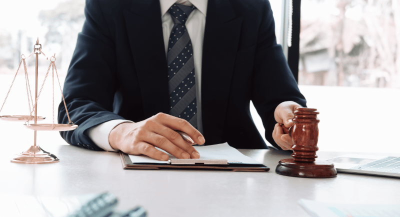 a man in a suit and tie is sitting at a desk