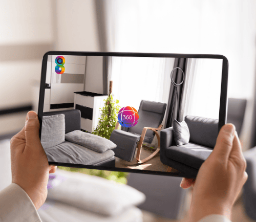 a person holding a tablet with a picture of a living room