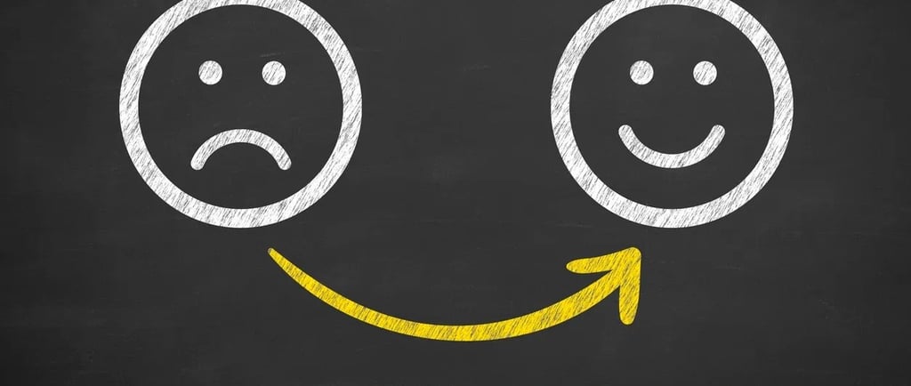 a smiley face drawn on a chalkboard with a smiley face