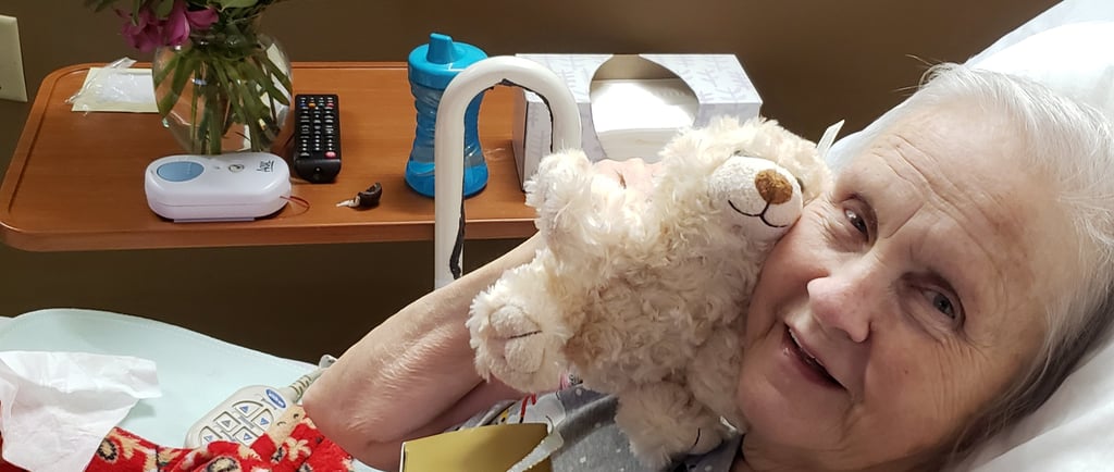 Lady hugging teddy bear