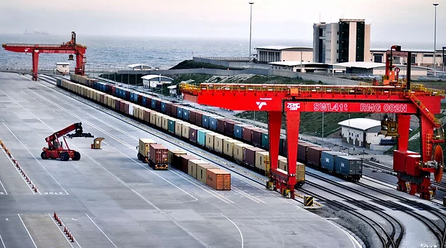 a train on a train track with a crane