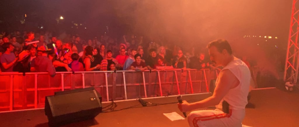 A top Freddie Mercury tribute singer entertains the crowd a a huge outdoor festival