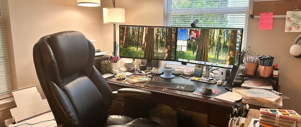A creative office with a computer, desk chair, and art supplies.