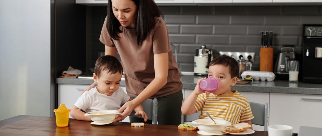 madre alimentando a sus dos hijos pequeños