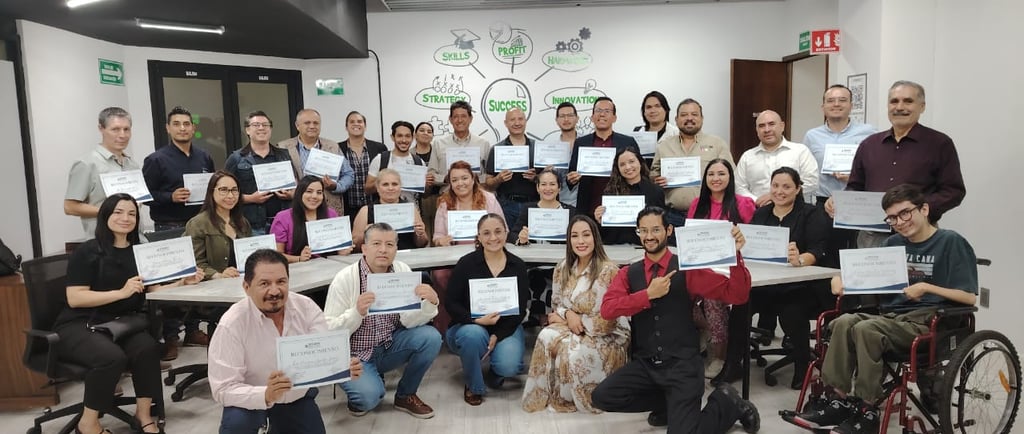 a group of people holding up certificates and holding certificates