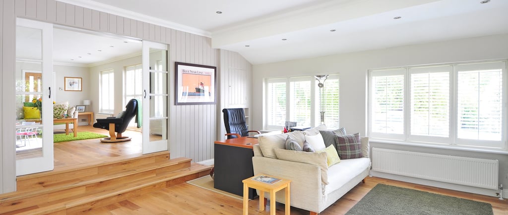 Living room that has beautiful hardwood floors and wood stairs