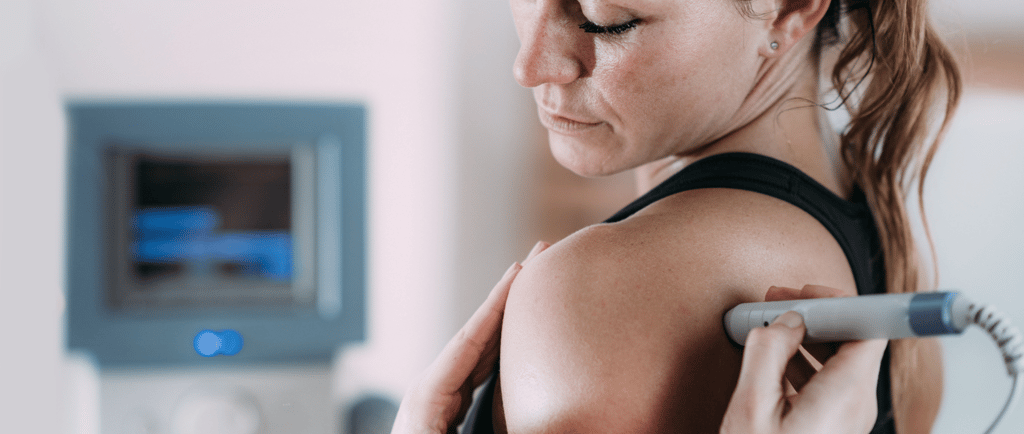 Laser therapy. Physical therapist treating patient's shoulder