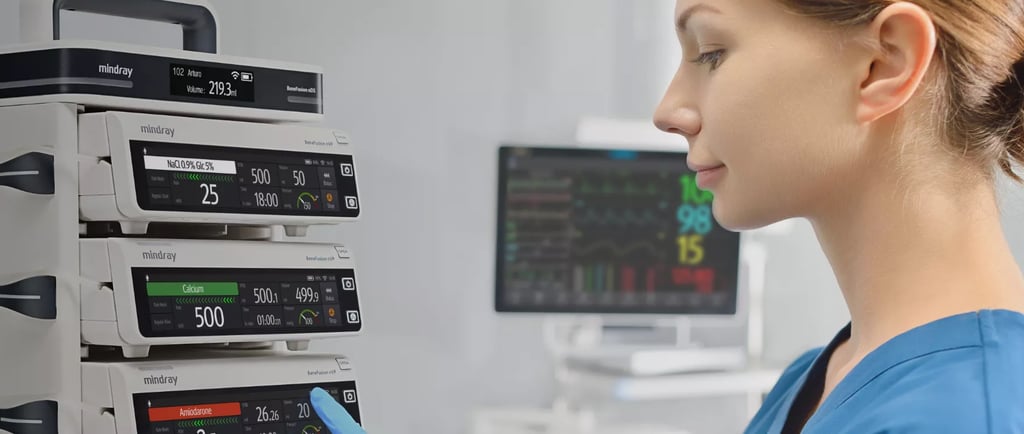 A medical professional monitoring a Mindray BeneFusion infusion pump system in a hospital setting.
