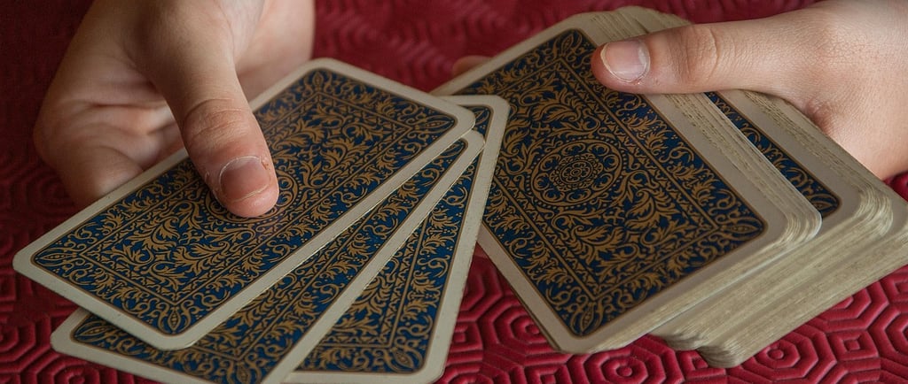 a person holding a card game of cards