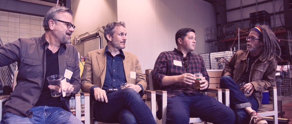 a group of men sitting on chairs in a room