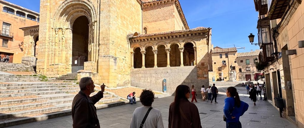 Host explaining the history to a private group tour in front of a medieval church