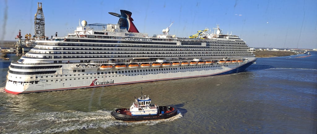 A cruise ship in background with a tugboat in foreground