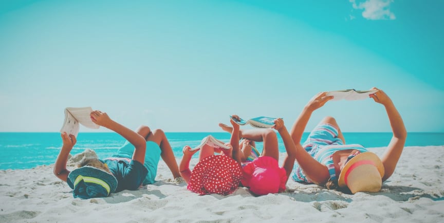 SWB Global Academy  Nurturing Curious Minds  Individualized Learning | Family reading on a beach