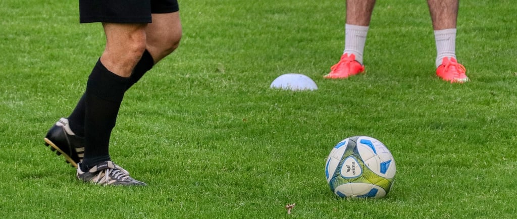 a soccer player is kicking a soccer ball