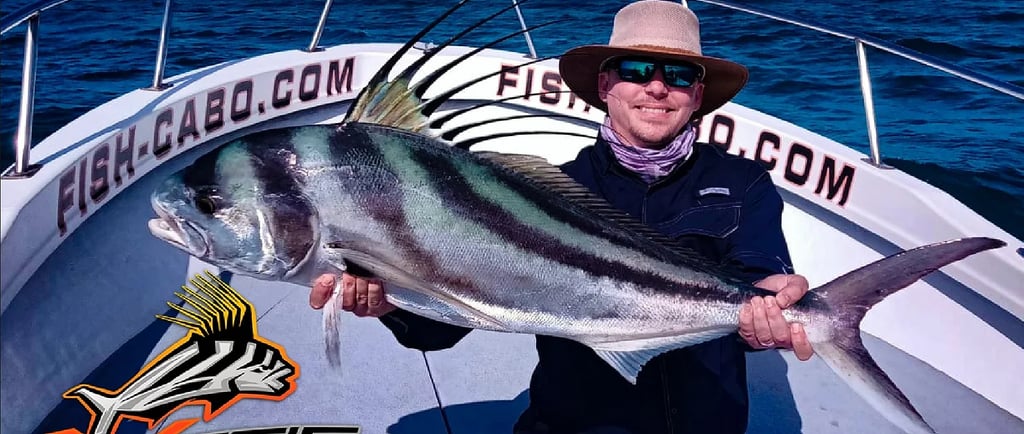 a man in a hat and sunglasses holding a fish