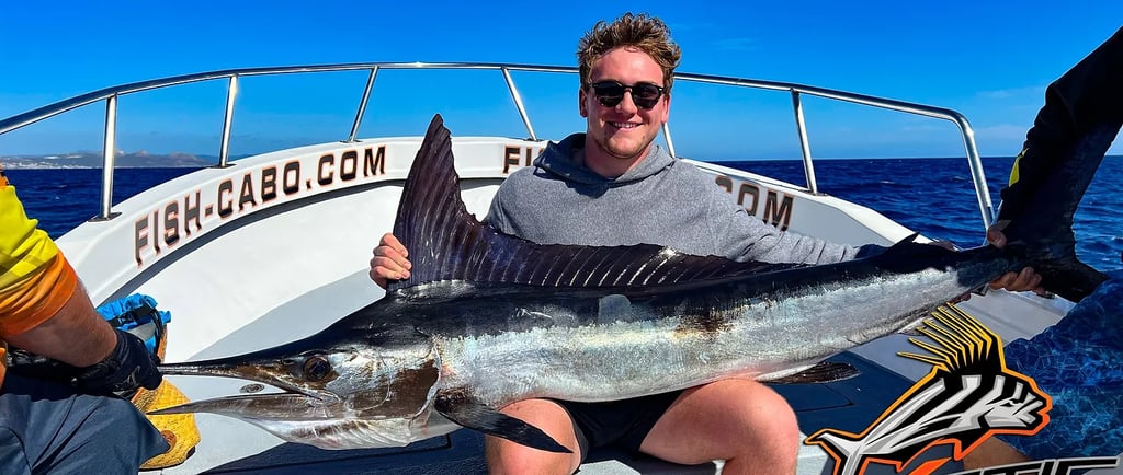 a man holding a fish on a boat