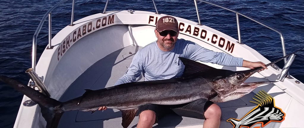 a man holding a large fish on a boat