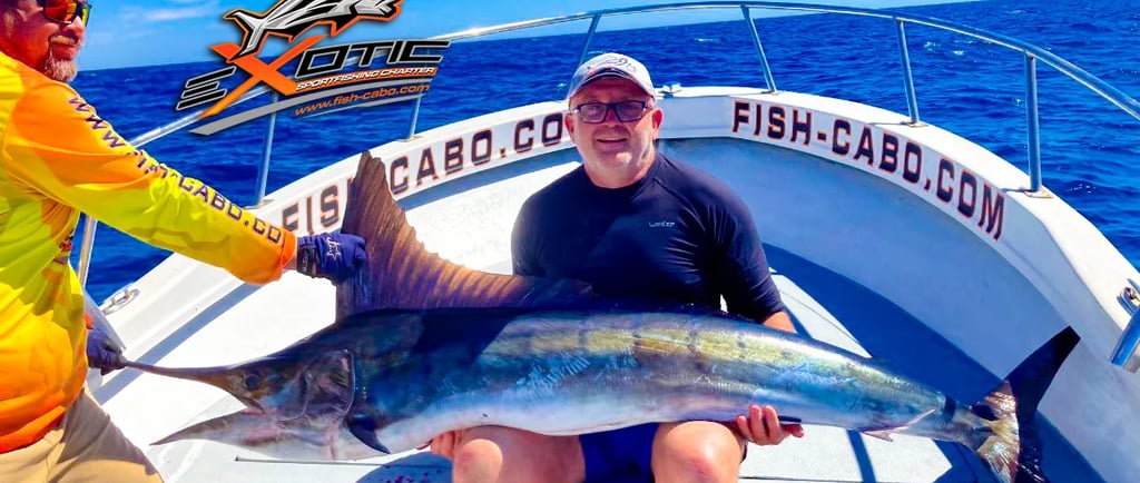 a man holding a fish on a boat