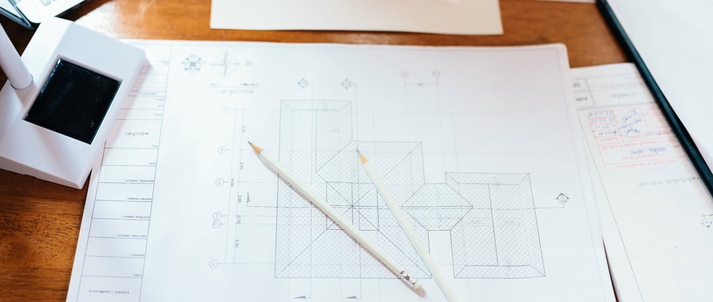 a desk with a laptop and a pen and pencil