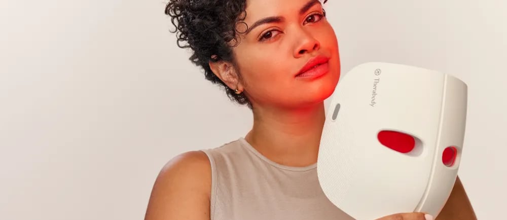 a woman with a red heart shaped mask on her face