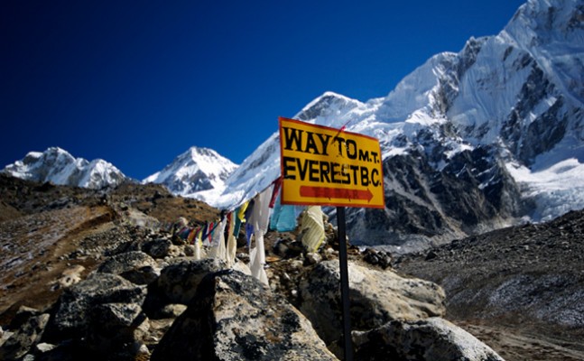 Yellow sign marking the trail to Mount Everest Base Camp in Nepal