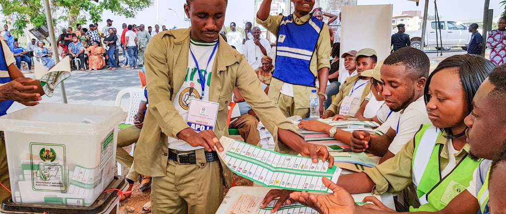 a corp member of the NYSC handling a ballot paper