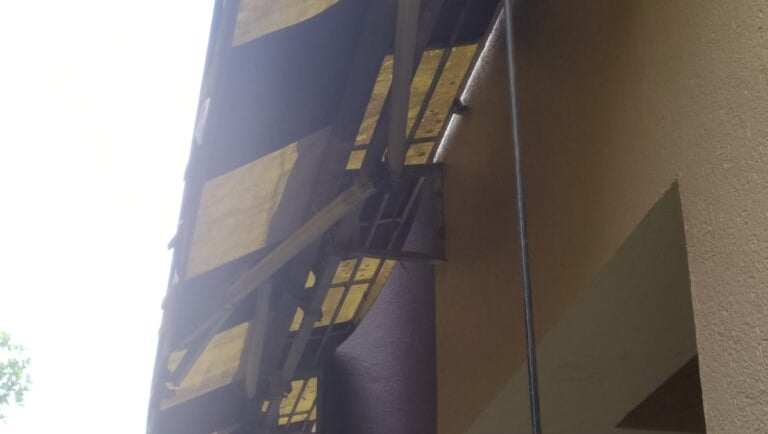a yellow and black awning on a building repair
