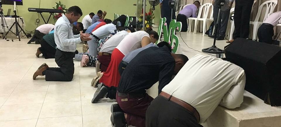 a group of people kneeling down on a stage