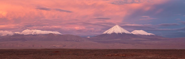 a mountain range with a mountain in the background