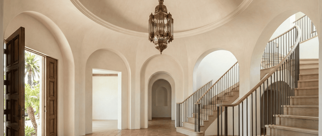 high end foyer with round soffit and double staircases