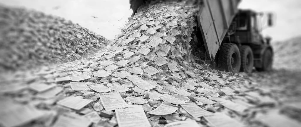 garbage truck dumping tons of paper resumes on a garbage dump