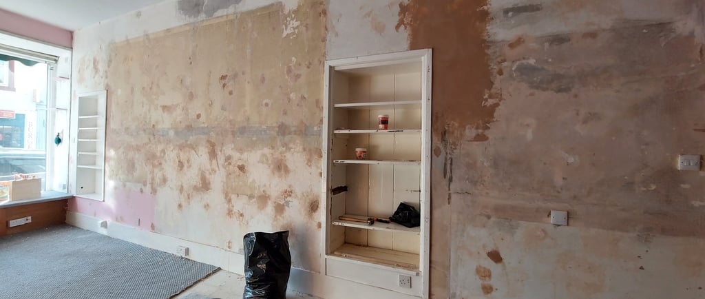 a wall during renovations with holes filled before papering