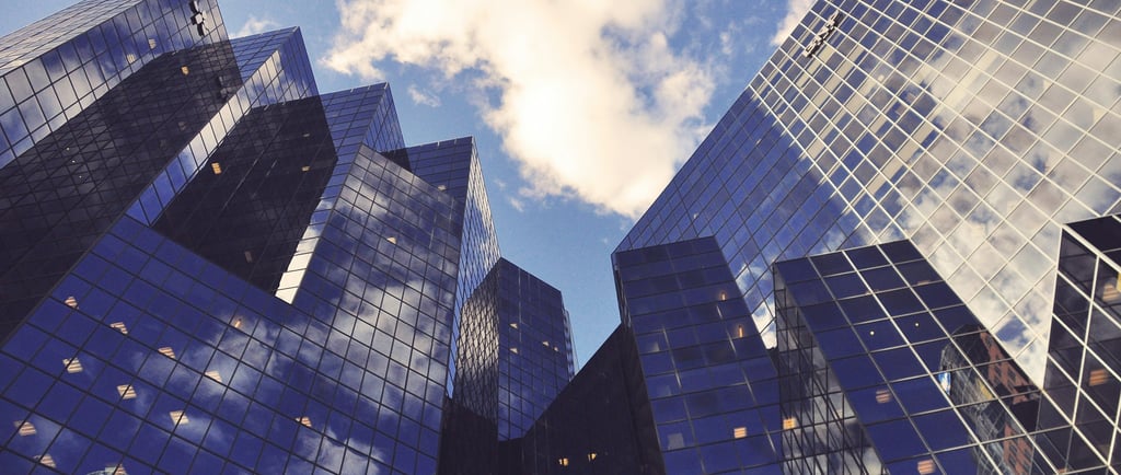 a group of tall buildings with a sky view of the city