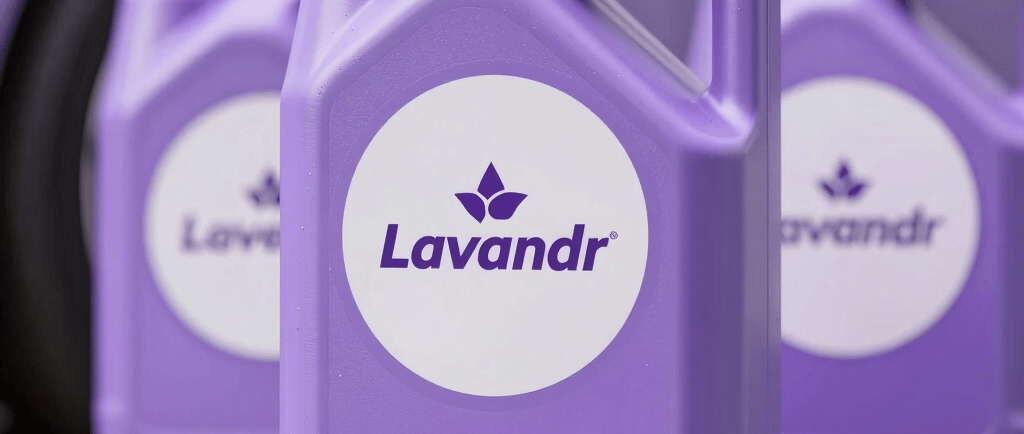 Lavandr brand purple automotive fluid jugs displayed in front of a matching purple car.