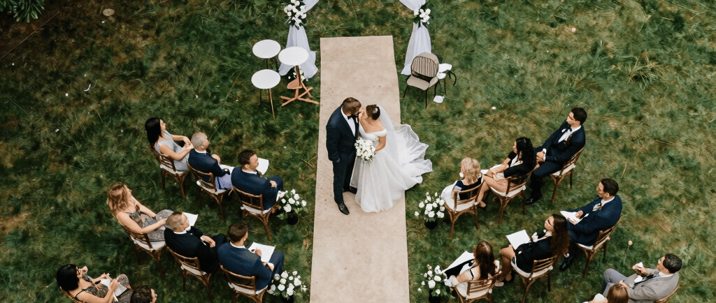 A bride and groom walking in front of a house