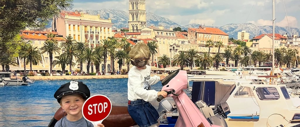 a young boy riding a pink scooter