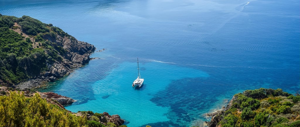  cruise ship sailing across blue lagoon ocean 