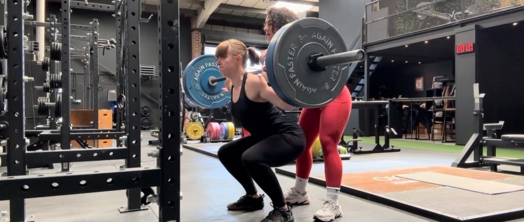 A barbell squat during a PT session
