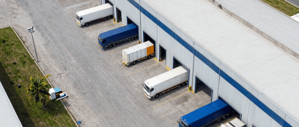 white sedan parked beside white van