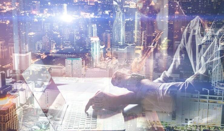 a man sitting at a desk with a laptop computer