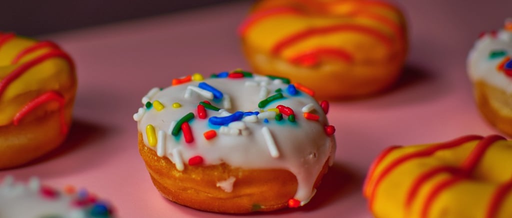 a bunch of donuts with sprinkles on them