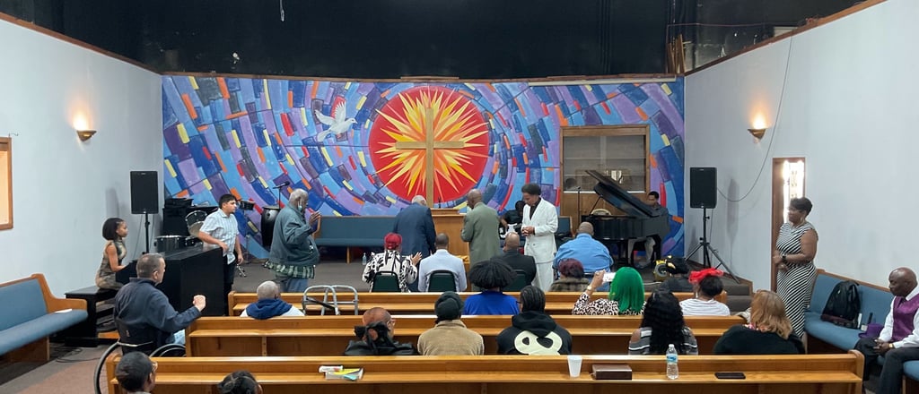 a group of people sitting in a church with a pulpit