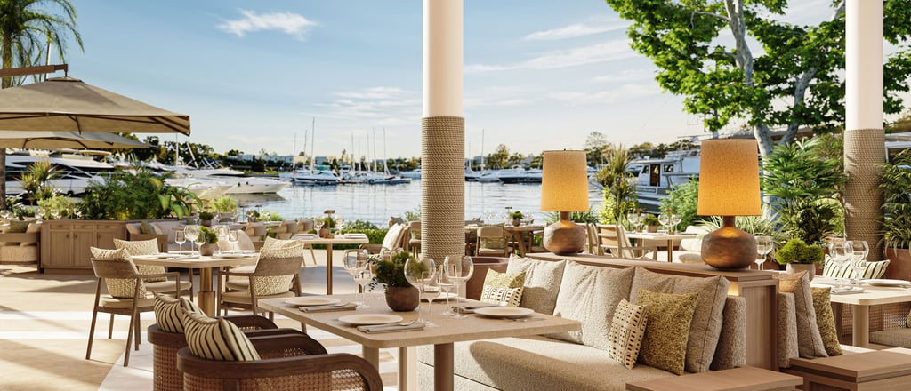 Luxury waterfront restaurant with elegant outdoor dining overlooking Sani  marina with yachts.