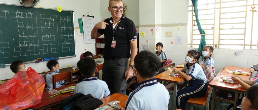 English teacher standing at the front of a classroom in Cambodia