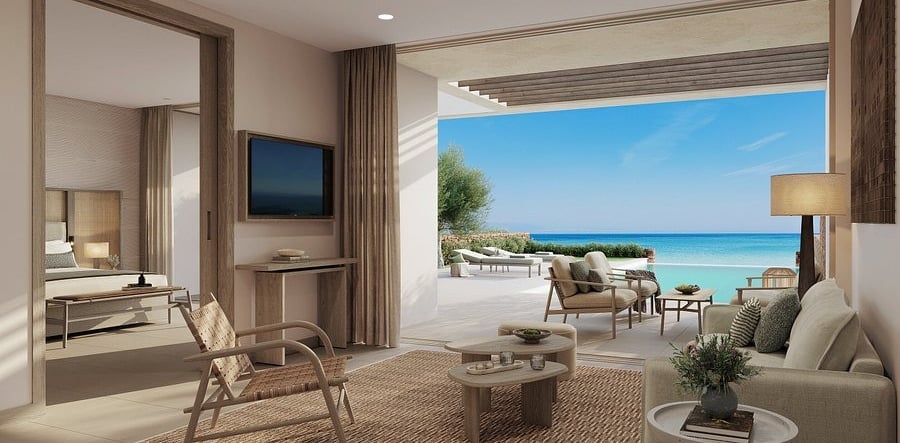 Luxury beach resort villa suite with a modern living room and private infinity pool overlooking the ocean.
