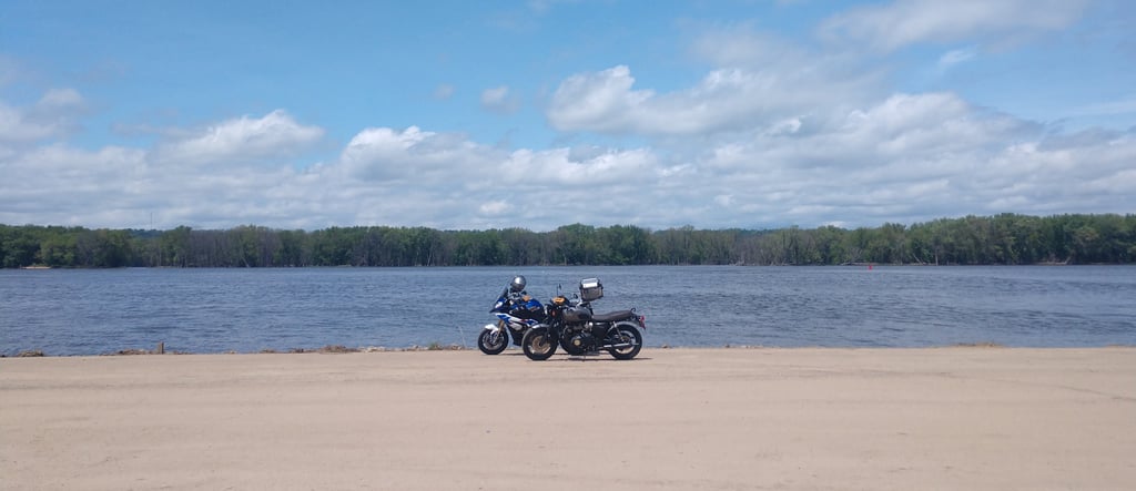 BMW S1000 XR and Triumph Bonneville on the shore of the Mississippi circa 2021