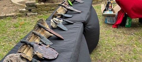 a table with a bunch of knives and knives on it