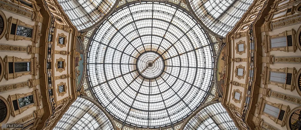 Iron framework and glass vaults curve gracefully, supporting the arcade’s luminous daylight structure designed by G. Mengoni.