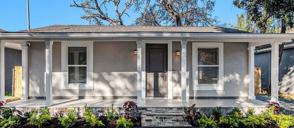 Exterior of a single-story home with a covered front porch and columns.